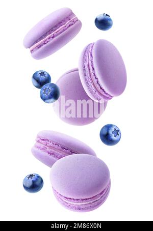 Flying macaroon cookies with fruits in the air, vertical isolated on white background Stock Photo