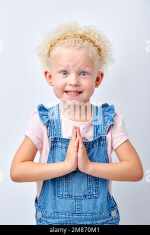 Surprise, excitement and fascination concept. Funny big blue eyed girl smiling, shocked with astonishing unexpected news, having amazed look, showing Stock Photo