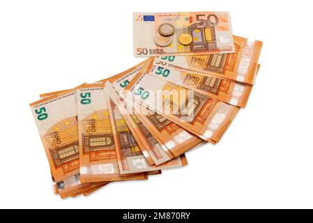 Fifty euro banknotes scattered in fan shape with one and two, euro and 10 cent coins on top, isolated on white, clipping path, financial concept and t Stock Photo