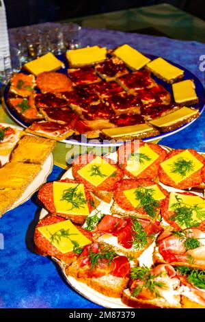 Small snacks finger food with salmon cheese salami ham tomato and herbs for celebration in Schierholz Lehe Bremerhaven Bremen Germany. Stock Photo