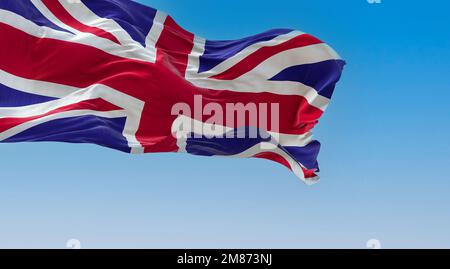 United Kingdom flag waving in the wind on a clear day. Union Jack. Blue field with red, white crosses of patron saints. Rippled fabric. Realistic 3d i Stock Photo