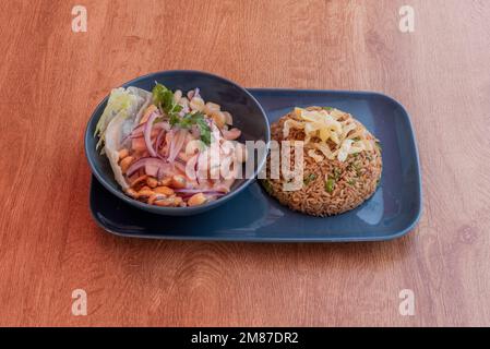 A Peruvian restaurant menu with sea bass ceviche and a bowl of arroz chaufa Stock Photo