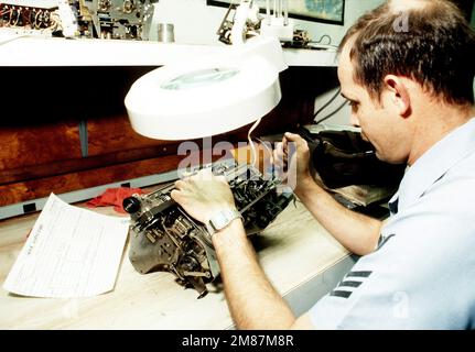 Radioman 1ST Class Blake repairs a typewriter in the Electronics Repair Shop of the Naval Communication Area MASTER Station, Atlantic. Base: Naval Air Station, Norfolk State: Virginia (VA) Country: United States Of America (USA) Stock Photo