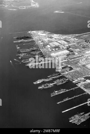 An aerial view of various ships moored at the station. Hampton Roads and the Hampton Roads Bridge-Tunnel are in the background. Base: Naval Air Station, Norfolk State: Virginia (VA) Country: United States Of America (USA) Stock Photo