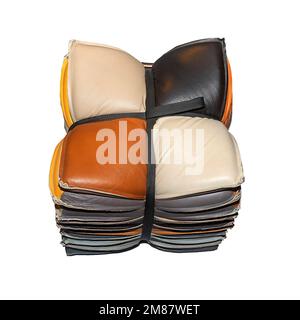 Stack of decorative colorful leather pillows tied in a bow isolated on white background Stock Photo