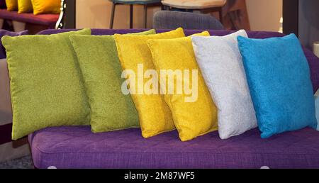 Row of colorful textile decorative pillows on a sofa Stock Photo