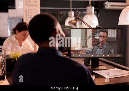 Employee talking with project manager speaking on corporate videocall on computer, discussing company strategy on webcam teleconference. Team leader listening to colleague on videoconference Stock Photo