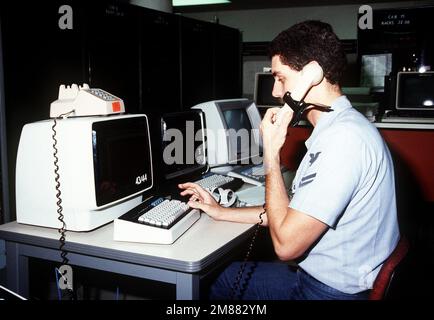 Data Processing Technician 2nd Class Trice uses a computer terminal to track a user's request in the Navy Regional Data Automatic Center. Base: Naval Air Station, Jacksonville State: Florida (FL) Country: United States Of America (USA) Stock Photo