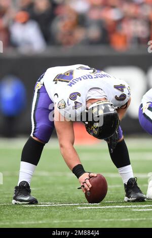 Baltimore Ravens center Tyler Linderbaum (64) signals during an