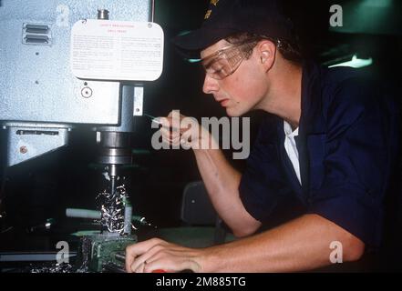 Aviation Structural Mechanic S (Structures) AIRMAN E. Spicuzza uses a drill press to bore a hole in a section of metal in an Aircraft Intermediate Maintenance Department (AIMD) shop. Base: Naval Air Station, Jacksonville State: Florida (FL) Country: United States Of America (USA) Stock Photo