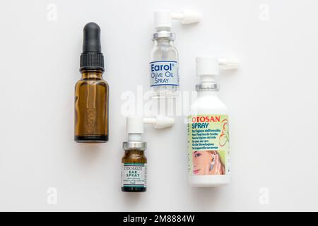 Bottles of medical and complementary ear treatments including Otomize, Otosan and Earol sprays, and olive oil dropper Stock Photo