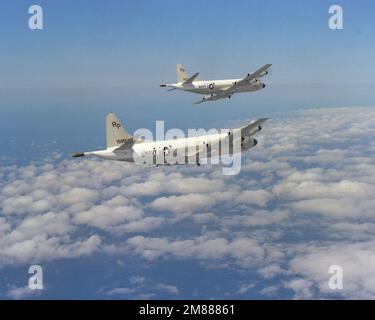 An air-to-air right rear view of two Patrol Squadron 31 (VP-31) P-3C Orion aircraft practicing formation flying during a special training exercise. Country: Unknown Stock Photo