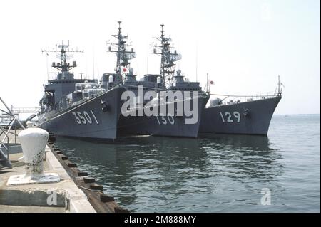 A starboard bow view of the Japanese training ship KATORI (TV-3501), the destroyer MATSUYUKI (DD-130) and the destroyer YAMAYUKI (DD-129) moored at a pier. The ships, part of the Japanese Maritime Self-Defence Force, are visiting Naval Operating Base, Norfolk. Base: Hampton Roads, Norfolk State: Virginia (VA) Country: United States Of America (USA) Stock Photo