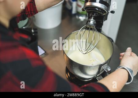 White kitchen machine and stand mixer on a wooden table in a bright design  apartment Stock Photo - Alamy