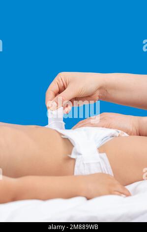 Cropped image of a mother changing her baby's diaper Stock Photo