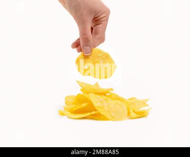 Hand holding potato chips isolated on a white background Stock Photo