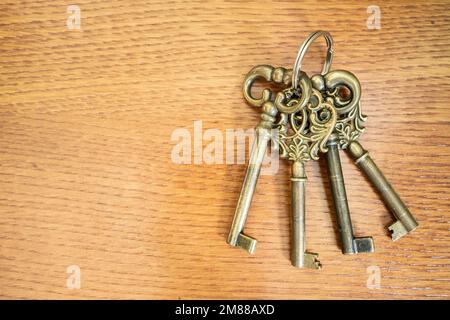 Three antique keys on old steel metal texture background Stock Photo
