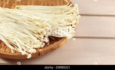 Enoki or Lily Mushrooms. Enokitake Flammulina velutipes, White Mushroom or Popular as Golden Needle Stock Photo