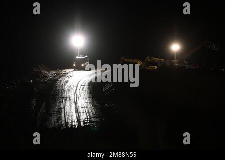 Erkelenz, Germany. 13th Jan, 2023. Police in a vehicle guard the access road to the Garzweiler open pit lignite mine. Credit: David Young/dpa/Alamy Live News Stock Photo