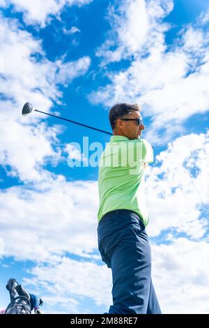 Detail of a golf player on the golf course, playing hitting the ball Stock Photo