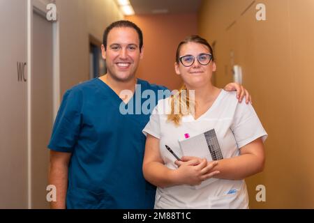 Dental clinic, assistant looking with the dental doctor at the agenda of the clients in the corridor of the boxes Stock Photo