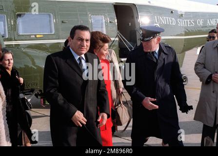 Egyptian President Mohammed Hosni Mubarak and his wife are accompanied by COL John Bacs, Vice Commander, Air Force District of Washington, as they walk away from a Marine Helicopter Squadron 1 (HMX-1) VH-3D Sea King helicopter. The Mubaraks and their party have come to the base to begin their journey back to Egypt following a state visit. Base: Andrews Air Force Base State: Maryland (MD) Country: United States Of America (USA) Stock Photo