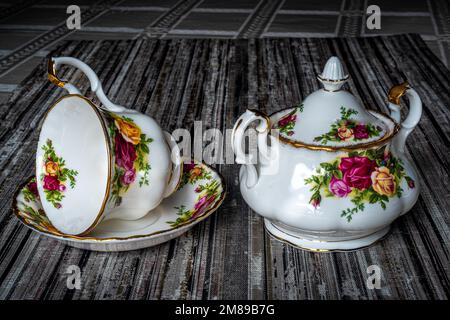 Royal Albert porcelain tableware, sugar bowl and coffee cup. Hand-painted flowers. Can be used to illustrate porcelain dishes in newspapers. Stock Photo