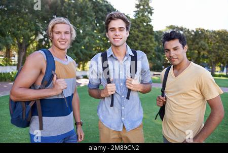 Ready to learn. Portrait of three students standing together in a park. Stock Photo