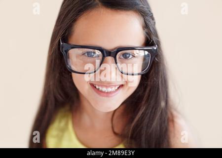 Ill grow into them...Closeup portrait of a cute young girl wearing big glasses. Stock Photo