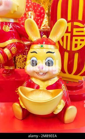 Tradition Chinese golden rabbit statue,2023 is year of the rabbit,Chinese characters on coin translation: good bless for new year. Stock Photo