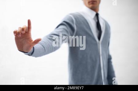 Product placement. Cropped image of a young nerdy guy holding an imaginary product. Stock Photo