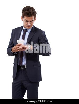 Just in time for the meeting. A handsome young businessman looking at his watch while holding a cup of coffee. Stock Photo