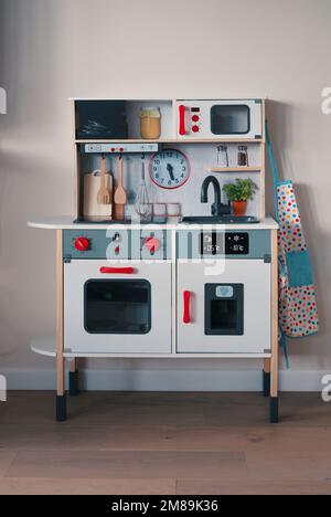 Toy kitchen set with oven, stove, sink and eating utensils Stock Photo