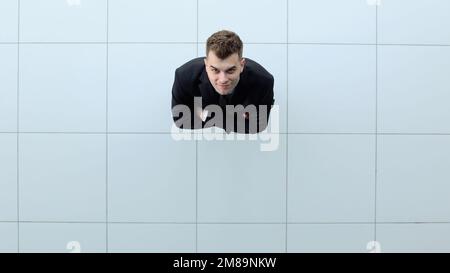 Celebrating success. Low angle view of excited young businessman keeping arms Stock Photo