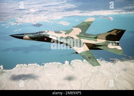 An air-to-air left side view of an F-111A aircraft from 431st Test and Evaluation Squadron flying over Lake Mead. State: Nevada (NV) Country: United States Of America (USA) Stock Photo