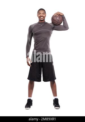 Basketball puts a smile on my face. Portrait of a handsome young basketball player standing in the studio. Stock Photo