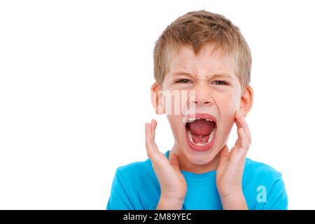 Frustrated kid, studio portrait and shouting with anger facial expression by white background for mental health. Boy child, crying and isolated with Stock Photo