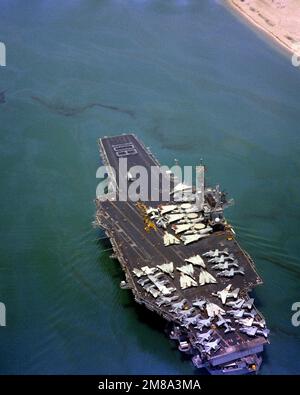 An aerial port quarter view of the aircraft carrier USS FORRESTAL (CV-59) transiting the canal. A formation of crewmen spells out '108' on the bow to signify that the ship has been at sea for 108 consecutive days. State: Suez Canal Country: Egypt (EGY) Stock Photo