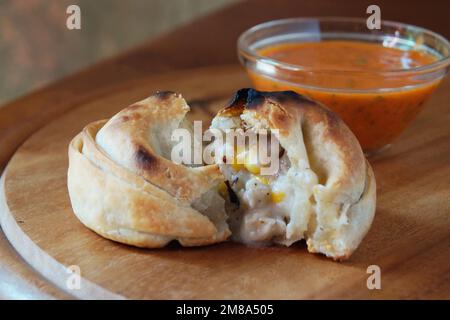 Argentine empanada stuffed with corn and meat. Stock Photo