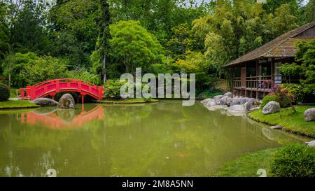 The Japanese garden of Toulouse, in Compans Caffarelli, with its lake, traditional building and red bridge Stock Photo