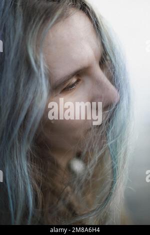 Close up thoughtful gray haired woman tilting head to side portrait picture Stock Photo