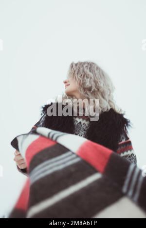 Close up curly haired lady in traditional clothes outdoors portrait picture Stock Photo