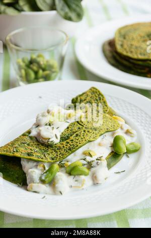 Green Pancakes with creamy  fava beans. Stock Photo