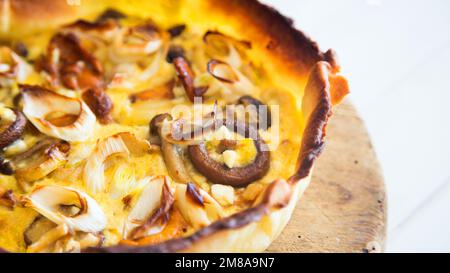 Mushroom French quiche. In gastronomy, a quiche is a type of savory tart derived from the French quiche lorraine. Stock Photo