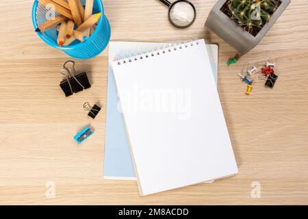 Back to school concept. Top view photo of notepads, pens, sharpeners, ruler, staplers, clips, markers and erasers on wooden table Stock Photo