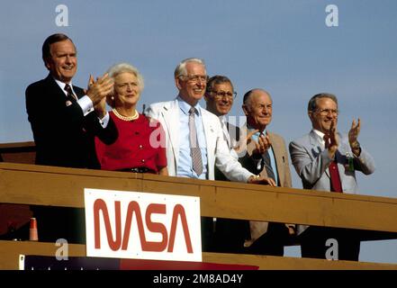 Vice President George Bush, left, applauds as the Space Shuttle Discovery touches down on Rogers Dry Lake, successfully completing Space Transportation System mission 26. Beside the vice president is his wife, Barbara; beside her is Dr. Dale Myers, deputy. Base: Edwards Air Force Base State: California (CA) Country: United States Of America (USA) Stock Photo