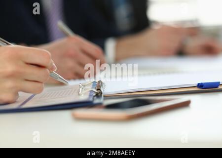 Closeup of people make up forms during business conference Stock Photo