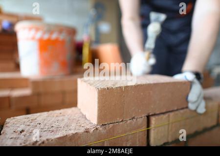 Brick orange wall set laying inside partition room at construction site Stock Photo