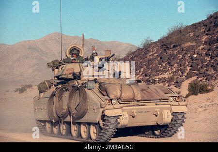 An M-2 Bradley Fighting Vehicle of the 24th Infantry Division (Mechanized) moves along a road at the National Training Center during an exercise. Base: Fort Irwin State: California (CA) Country: United States Of America (USA) Stock Photo