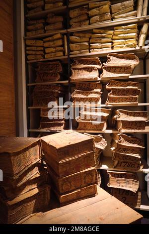 Interior gallery, displaying stacks of old bank ledger, yellowed, sepia record books. At the Museo dell'Archivio Storico del Banco di Napoli, the Bank Stock Photo